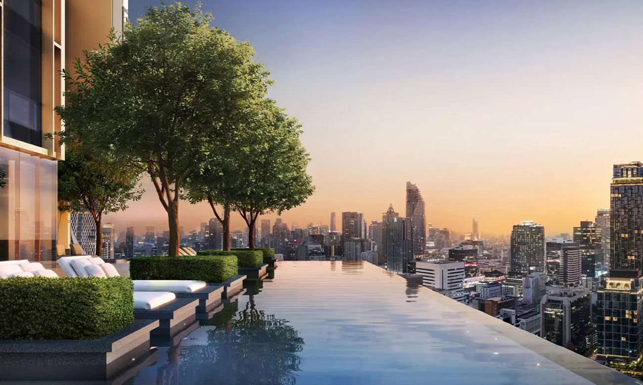 nfinity pool overlooking a city skyline at sunset, with lush greenery and lounge chairs along the edge, creating a serene, luxurious ambiance