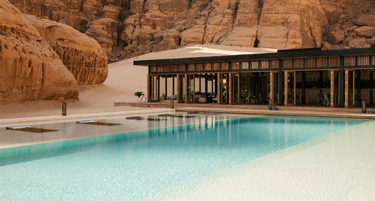 A luxurious pool set in the middle of desert rock formations.